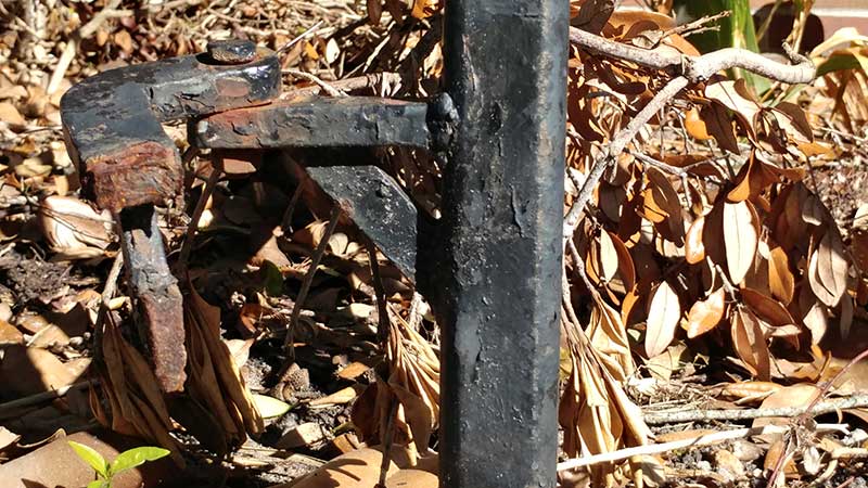 Steel hinges rusted off the gate frame