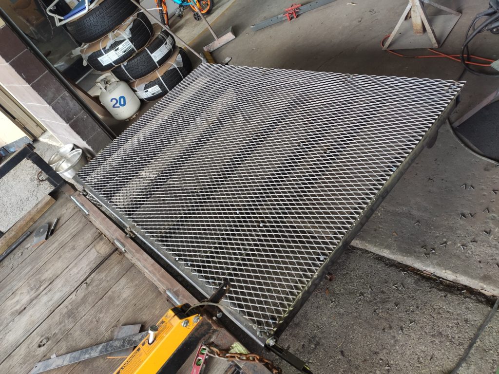 Metal mesh over trailer gate frame